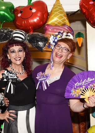 Melody and Jo dressed up at a party surrounded by balloons